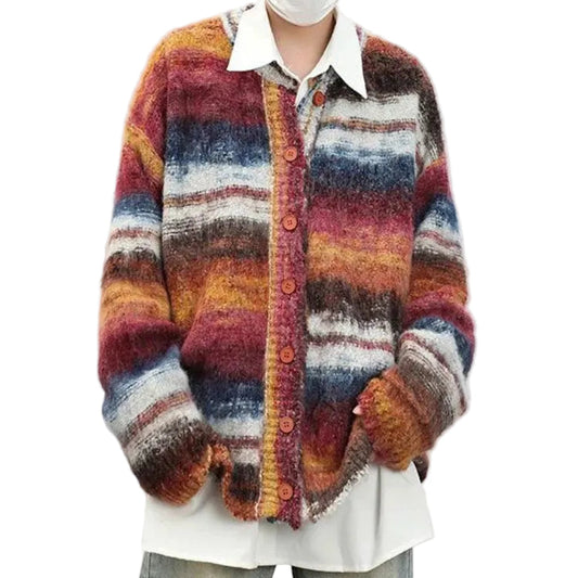 Person wearing a colorful striped sweater with a white shirt underneath on a plain background